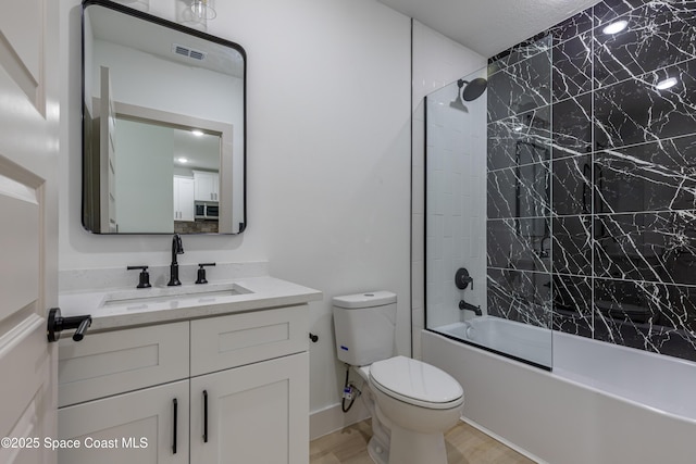 full bathroom with visible vents, toilet, wood finished floors,  shower combination, and vanity