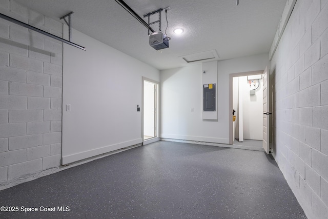 garage featuring a garage door opener, concrete block wall, electric panel, and baseboards