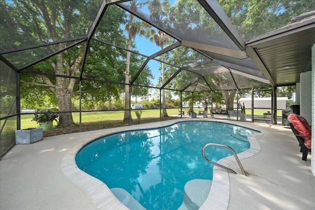 outdoor pool with a lanai and a patio area