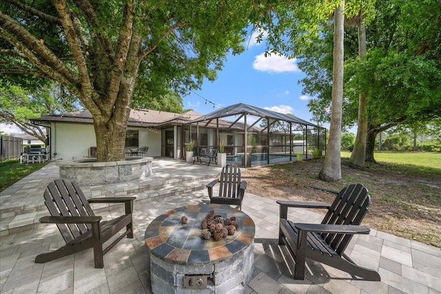 view of patio with glass enclosure, an outdoor fire pit, and an outdoor pool