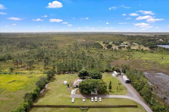 drone / aerial view with a wooded view