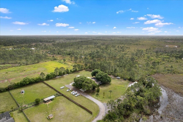 birds eye view of property featuring a forest view