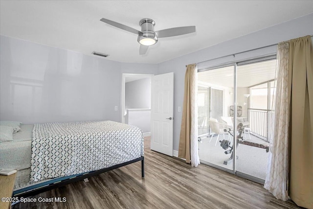 bedroom with baseboards, wood finished floors, visible vents, and a ceiling fan