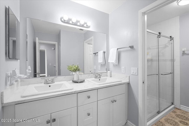 full bath featuring double vanity, a shower stall, and a sink