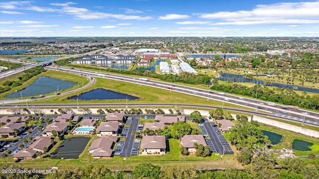 birds eye view of property with a water view and a residential view