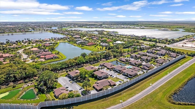 bird's eye view featuring a water view and a residential view