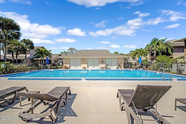 community pool featuring fence and a patio