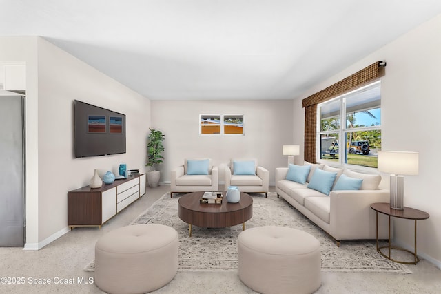 living room featuring speckled floor and baseboards