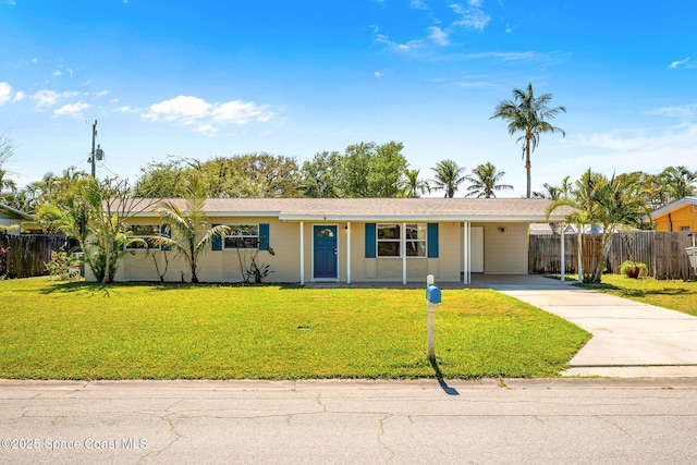 single story home featuring driveway, an attached carport, a front yard, and fence