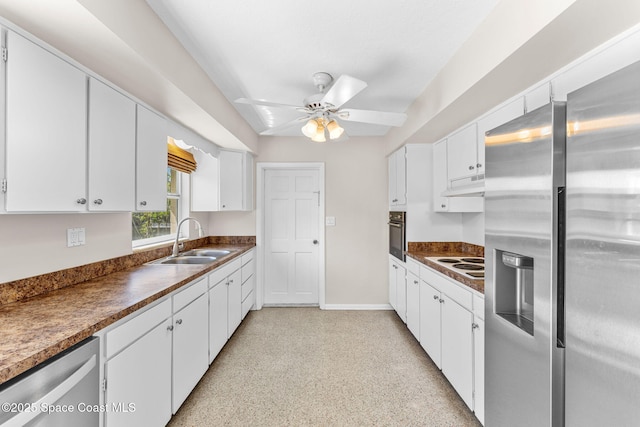 kitchen featuring appliances with stainless steel finishes, a sink, white cabinets, and under cabinet range hood