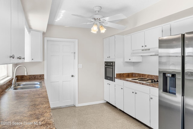 kitchen with dark countertops, oven, under cabinet range hood, stainless steel refrigerator with ice dispenser, and a sink