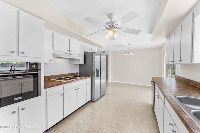 kitchen featuring stainless steel fridge, dark countertops, white electric cooktop, oven, and under cabinet range hood