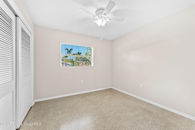 unfurnished bedroom with a ceiling fan, baseboards, a closet, and speckled floor