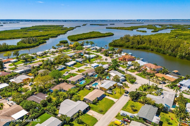 birds eye view of property with a residential view and a water view