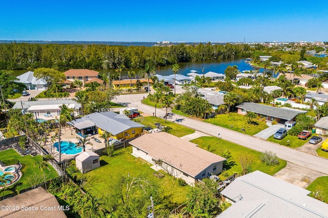 drone / aerial view featuring a water view and a residential view