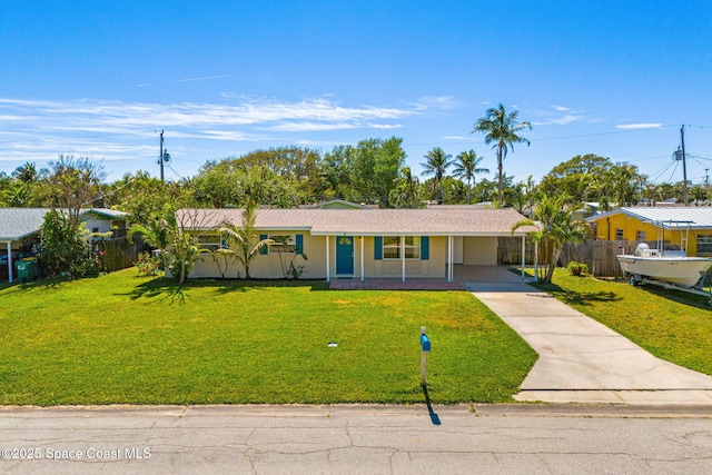 692 Bermuda Rd, Cocoa Beach, FL 32931 - ranch-style home with a front yard, concrete driveway, and fence
