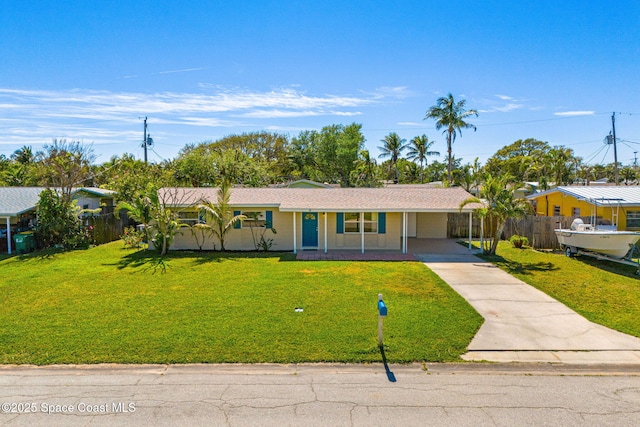 ranch-style home with a front yard, concrete driveway, and fence