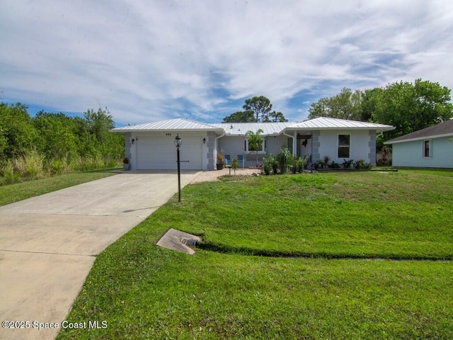 ranch-style house featuring an attached garage, a front yard, metal roof, driveway, and a standing seam roof