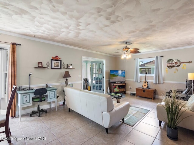 living area with light tile patterned floors, a ceiling fan, and ornamental molding