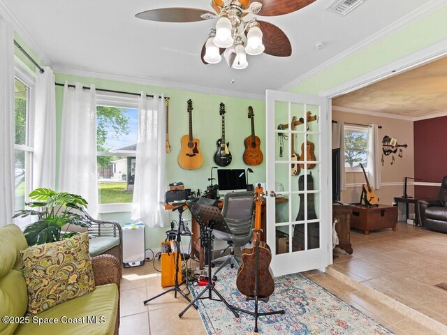 office space featuring tile patterned floors, plenty of natural light, visible vents, and ornamental molding