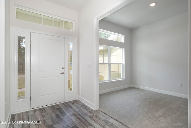 foyer entrance with recessed lighting, baseboards, and wood finished floors