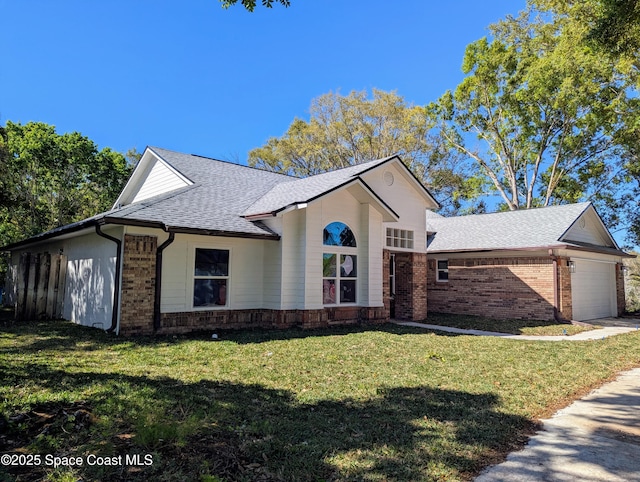 single story home featuring a front yard, a garage, brick siding, and a shingled roof