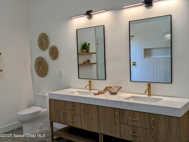 full bathroom with a sink, toilet, double vanity, and tile patterned flooring