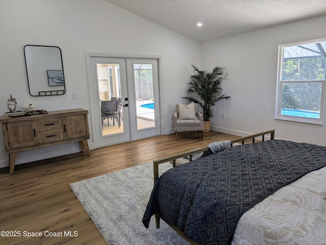 bedroom with wood finished floors, lofted ceiling, recessed lighting, access to exterior, and french doors