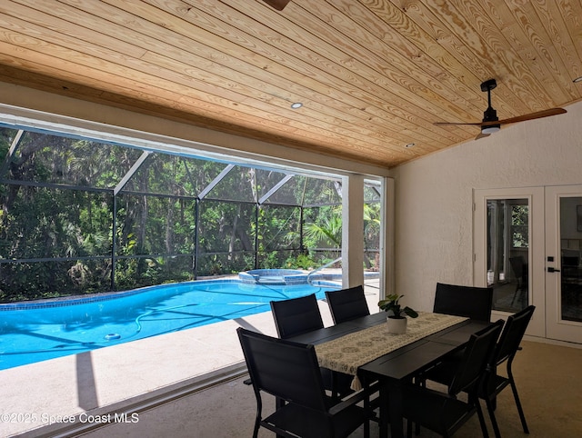 view of pool with a ceiling fan, a pool with connected hot tub, outdoor dining area, a lanai, and a patio area