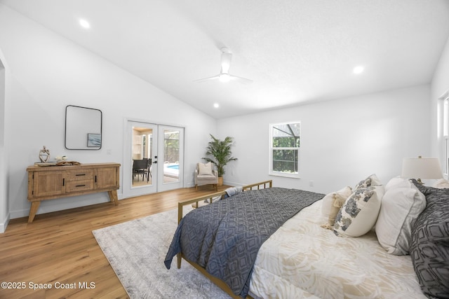 bedroom with access to outside, recessed lighting, french doors, light wood-style floors, and vaulted ceiling
