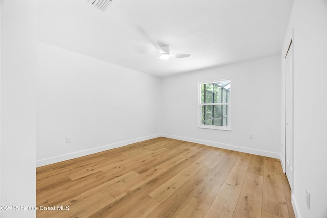 empty room with visible vents, baseboards, light wood-style flooring, and a ceiling fan
