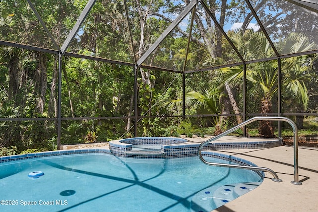view of pool featuring a lanai, a patio area, and a pool with connected hot tub