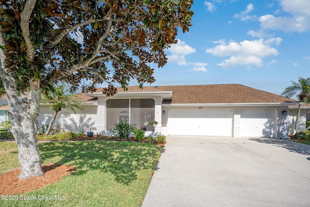 view of front of property featuring a garage, driveway, a front lawn, and stucco siding