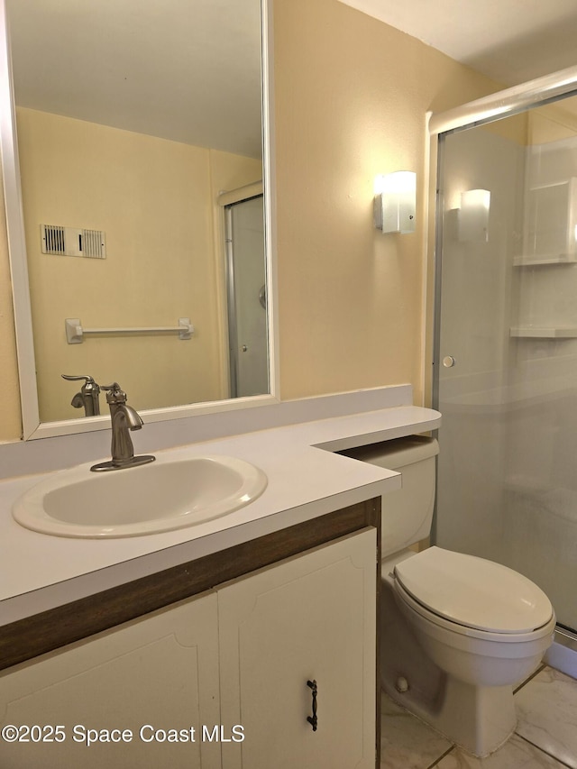 bathroom with a stall shower, marble finish floor, vanity, and toilet