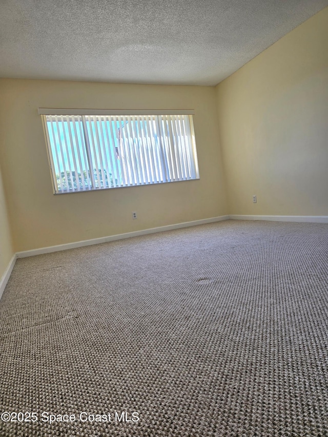 unfurnished room with plenty of natural light, carpet flooring, and baseboards