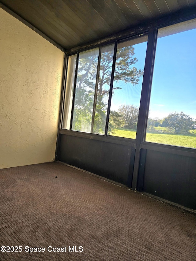 unfurnished sunroom featuring wood ceiling