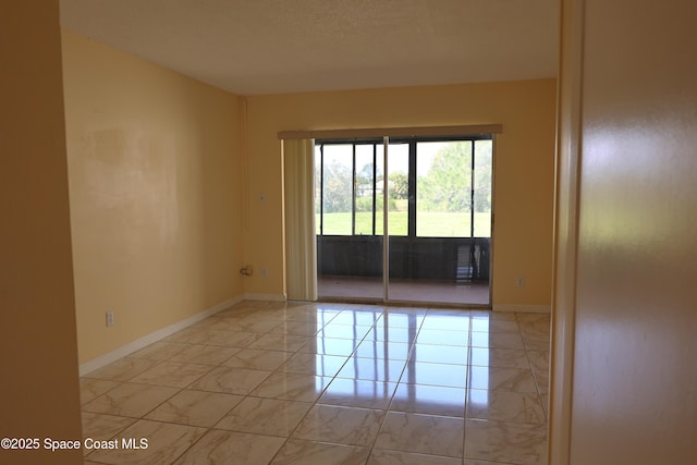 empty room with marble finish floor and baseboards