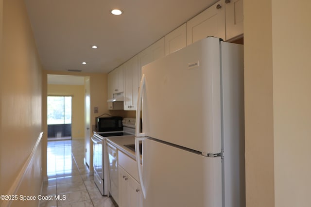 kitchen with recessed lighting, white cabinets, light tile patterned flooring, white appliances, and under cabinet range hood