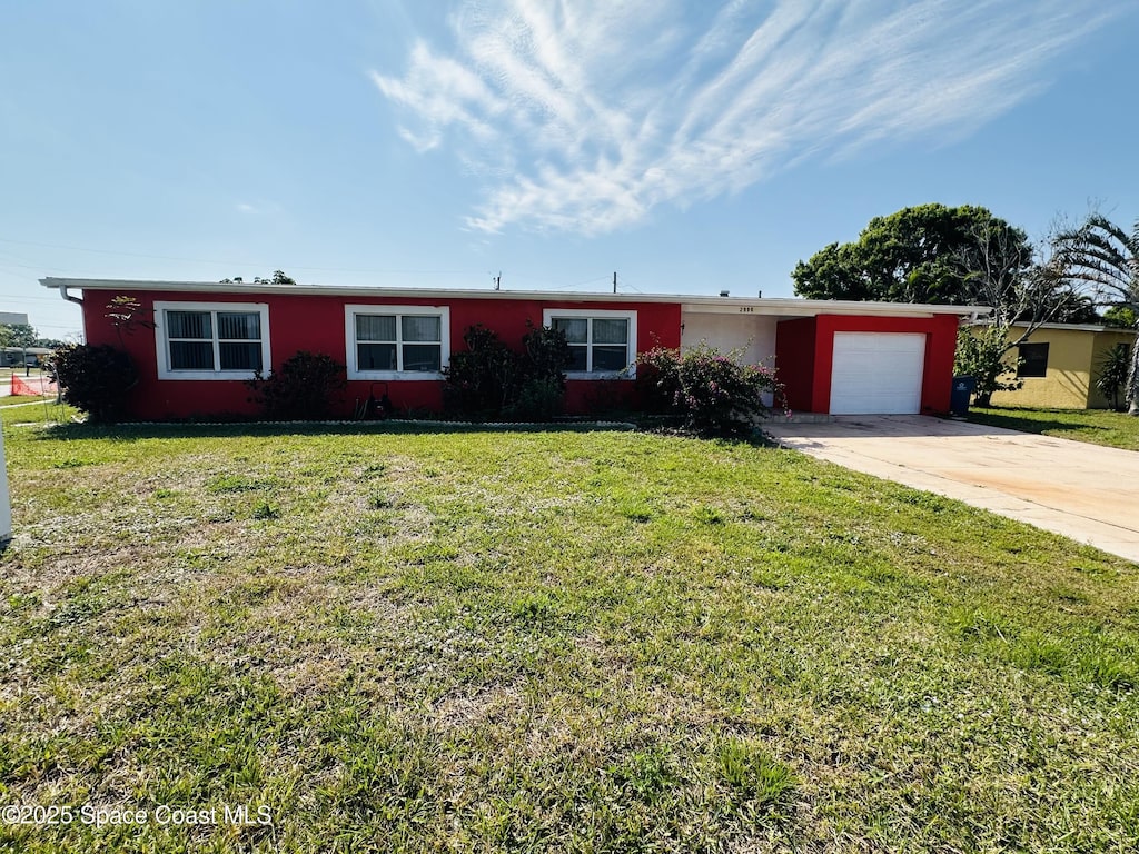 ranch-style home with a garage, driveway, a front lawn, and stucco siding