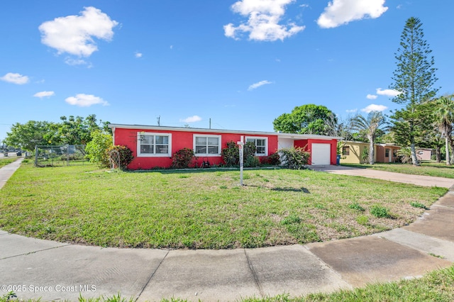 ranch-style home with a front lawn, fence, a garage, and driveway