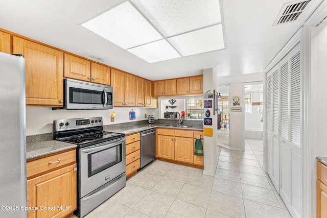 kitchen with light tile patterned floors, visible vents, appliances with stainless steel finishes, and a sink