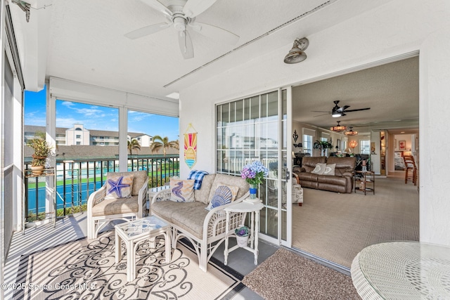 sunroom featuring a ceiling fan