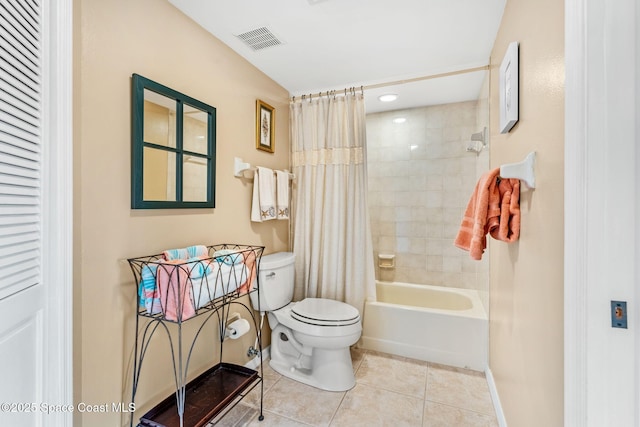 bathroom featuring tile patterned floors, visible vents, toilet, shower / bath combo, and baseboards