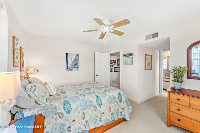 bedroom featuring light carpet, visible vents, a ceiling fan, and baseboards