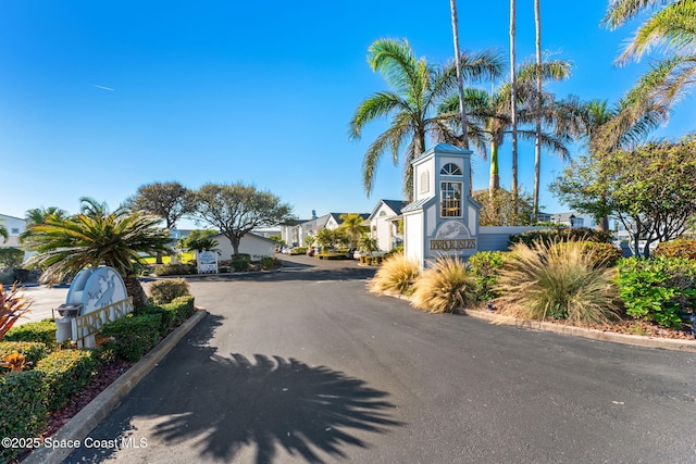 view of street featuring a residential view and curbs