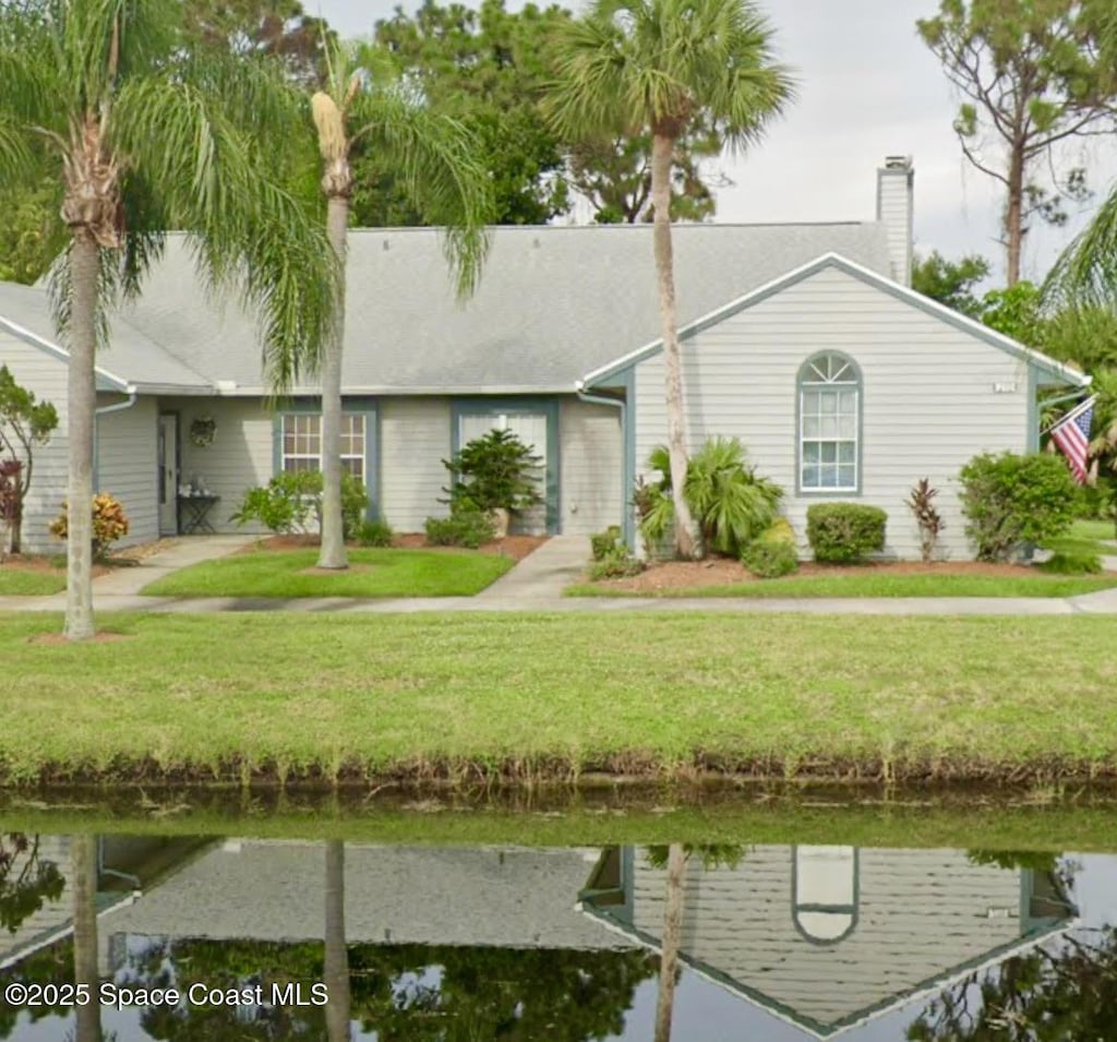 view of front of home with a front lawn and a chimney