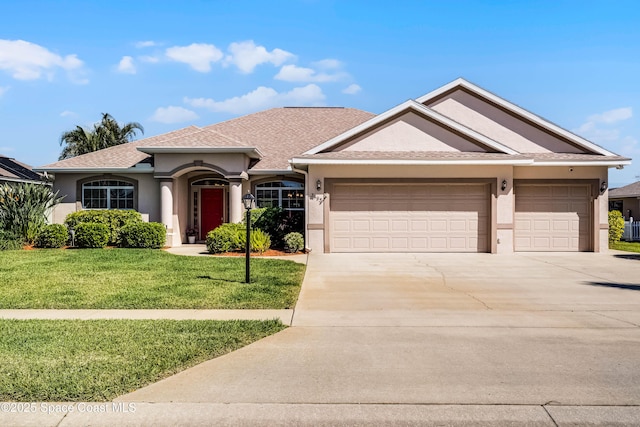 single story home featuring an attached garage, driveway, a front yard, and stucco siding