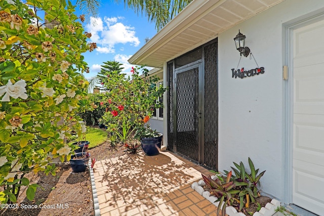 2033 Thistle Dr, Melbourne, FL 32935 - doorway to property with a patio and stucco siding