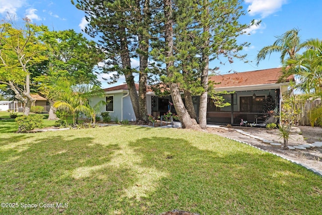 2033 Thistle Dr, Melbourne, FL 32935 - ranch-style home with stucco siding and a front yard