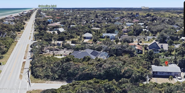 drone / aerial view featuring a water view and a residential view